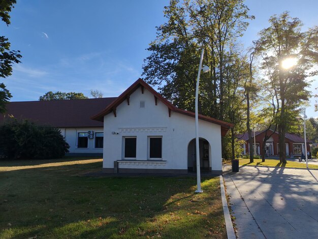 quaint singlestory building is nestled lush green trees clear blue sky peaceful 941451 8501